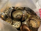 a bag full of old brass knobs in a plastic bag