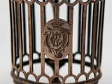 a metal birdcage with a crest on it