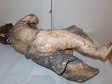 a statue of a man laying down on a bed