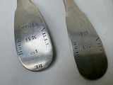 two spoons that are sitting on a table