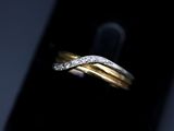 a close up of a gold and diamond ring on a cell phone