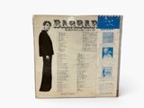 an old record with a picture of a man in a black suit