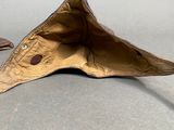 a brown umbrella that is laying on the ground