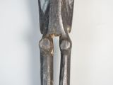 a wooden sculpture of a man with his hands on his hips
