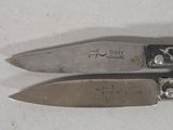 two knives that are sitting next to each other on a table