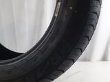 a close up of a tire on a table with a white background