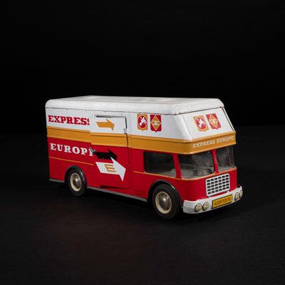 a toy bus that is sitting on a black surface