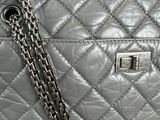 a grey purse with a chain hanging from it