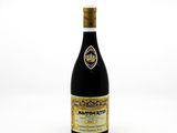 a bottle of wine sitting on top of a white table