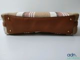 leather case with a plaid pattern on it sitting on top of a white table