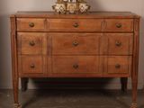 a dresser with a mirror on top of it in a room