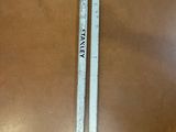 two pencils sitting on top of a wooden table next to each other