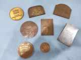 some of the coins are sitting on the table next to each other