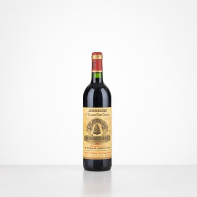 a bottle of red wine sitting on top of a table