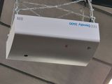 a white box hanging from a chain on the ceiling