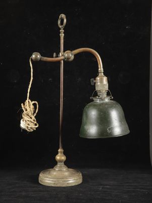 an old fashioned lamp with a rope and a light bulb on it