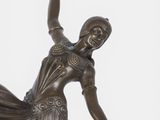 bronze statue of a woman in a long dress with her arms outstretched