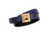 a close up of a blue leather bracelet with a gold square buckle