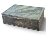 a glass box with a design on it on a white surface