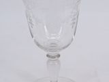 an empty wine glass sitting on top of a white table