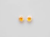a pair of yellow sapphire and diamond earrings on a white background