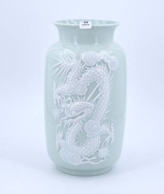 a green vase with a dragon on it on a white background