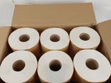 plusieurs rouleaux de papier toilette dans une boîte en carton posée sur une surface blanche