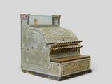 an old cash register machine with a glass top