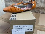brand new women ' s shoes in box on a cardboard box