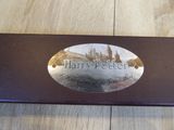 a metal plaque on a wooden table that says harry potter