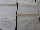 several drawings of people standing in a line on a table