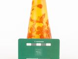 a yellow vase sitting on top of a green card holder