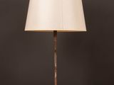 a lamp on a wooden table with a white shade