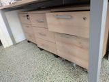 a desk with drawers and a computer on top of it