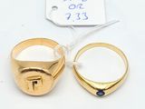 two gold rings with a blue stone in the middle of them