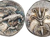 a silver coin with an image of a bird on it