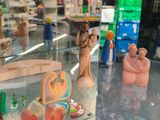 several figurines are on display in a glass case in a store