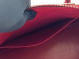 the inside of a red purse with a zipper on it