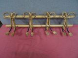 five pairs of scissors hanging on a rack on a table