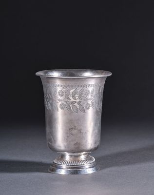 a silver cup that is sitting on a table