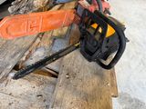 a chainsaw that is sitting on top of a piece of wood