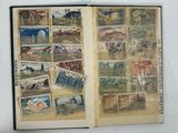 an open book with stamps on it on a table