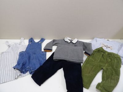 three clothes laid out on a white table