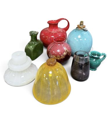 many different colored vases on a white surface