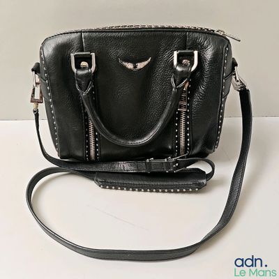 a black purse that is sitting on a table