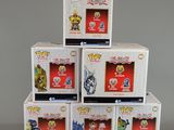 a stack of five boxes of pokemon toys sitting on top of each other
