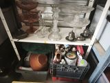 a shelf with a lot of glassware and other items on it