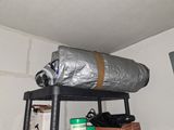 a metal shelf with a roll of foil on top of it