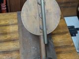a wooden table with a metal object on top of it