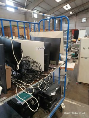 a lot of computer equipment on a cart in a warehouse